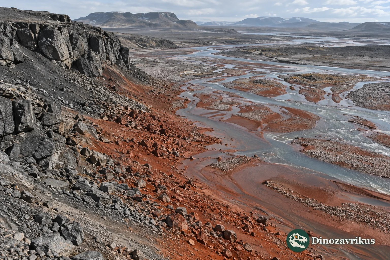 Red oxidised sediment beside darker fresh rock in a barren Siderian river landscape